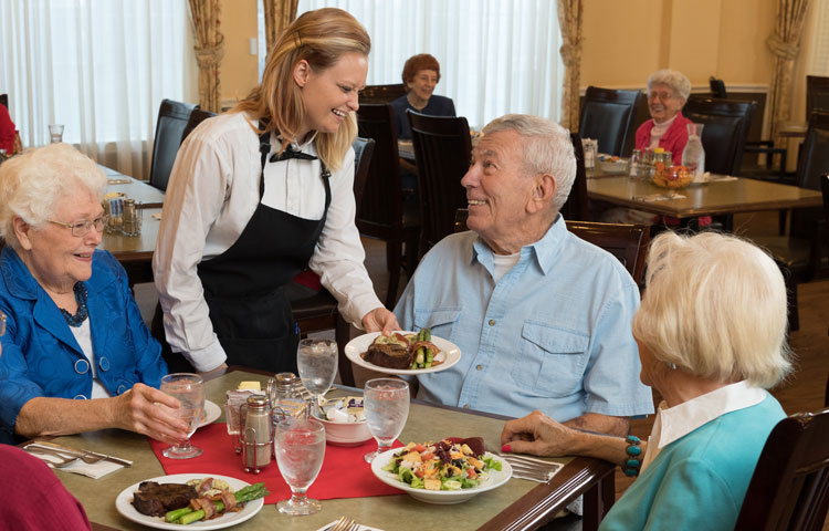 At the table - a lot of happy dining people image